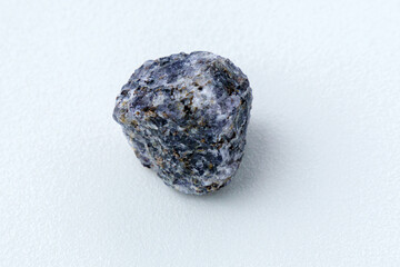Crystal of cordierite iolite gem stone cutout, raw mineral, white background