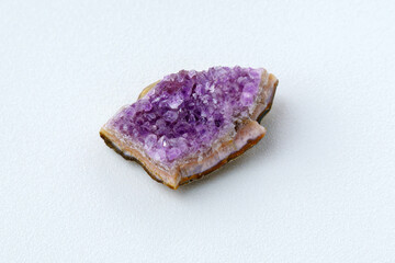 Crystal stone is a mineral. Purple rough amethyst quartz crystals, white background