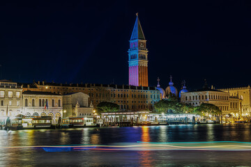 Venice night sea view of St Marks illuminated waterfront with Campanile, Basilica di San Marco Cupolas & Doges palace seen from Dorsoduro.