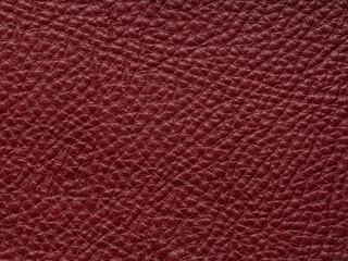 Red quality leather, natural material with design lines pattern or red abstract background. Can use wallpaper or backdrop luxury event, design upholstered furniture, clothing. Genuine leather texture.