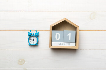 March 1st. Image of March 1 wooden block calendar on colored background. Summer day. Empty space for text