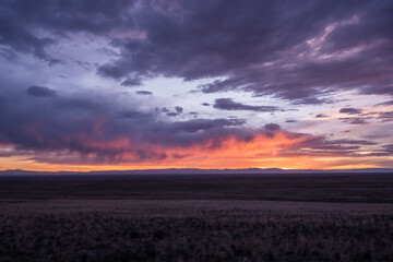 Evening Clouds Glow Pink and Orange Over High Plains of Colorado