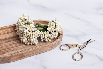 Decorative artificial flowers for creativity and scissors. Decorative bouquets. Space for text