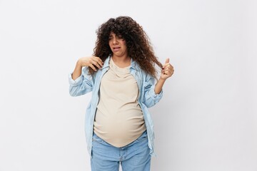 Pregnant woman hair loss during pregnancy, health problems and vitamin deficiencies on a white isolated background in a t-shirt with a blue shirt