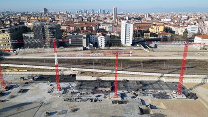 EUROPE, ITALY, MILAN 2023 - Drone aerial view of Scalo Porta Romana, building construction of Olympic Village for Milan-Cortina 2026 Winter Olympics games in downtown of the city near Prada Tower   - obrazy, fototapety, plakaty
