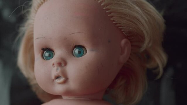 scary doll twitches its eye close-up footage