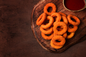 crispy chicken rings, fried, on a wooden board, close-up,