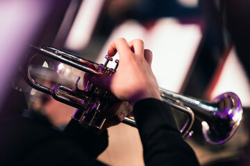A musician playing the trumpet during an orchestra concert
