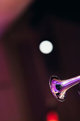 A shiny trumpet bell against bright stage lights during a solo of a jazz concert