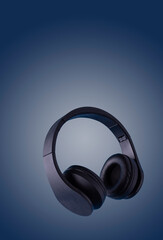 Fototapeta na wymiar black headphones on a blue background, copy space