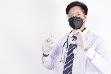 Study of COVID-19 infection. Male doctor examines medicine for illness, man mask with syringe and jar in front