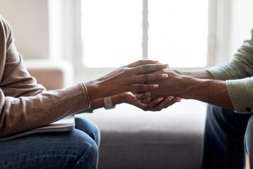 Therapist holding hands of man patient provide psychological help, cropped