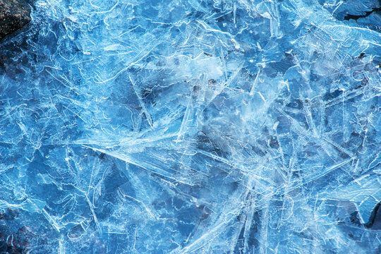 Ice surface of the river. Texture of ice shards. Winter background.