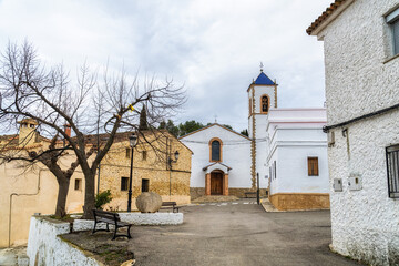 Fototapeta premium Small rural town, with church, in cloudy and rainy day. Navalon, Valencia (Spain)