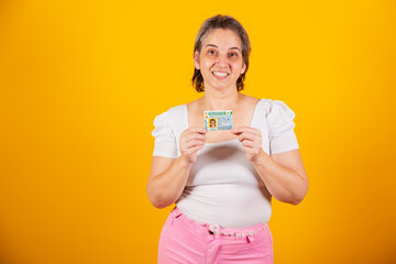 Adult Brazilian woman holding driver's license.