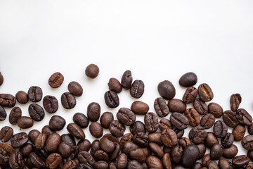 Fresh roasted brown coffee beans on white background