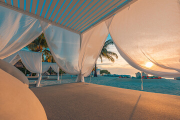 Obraz na płótnie Canvas White beach canopy closeup at sunset. Luxury beach tents exotic resort. Summer beach concept, relaxation and tranquility design. Serenity view, carefree, wellbeing wellness spa seaside travel vacation