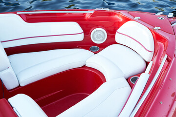 Сlose-up of the red speedboat bow with white leather seats                            