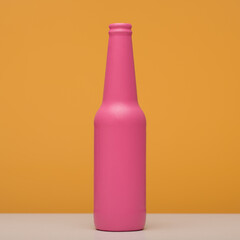 Pink bottle closeup on a yellow background.