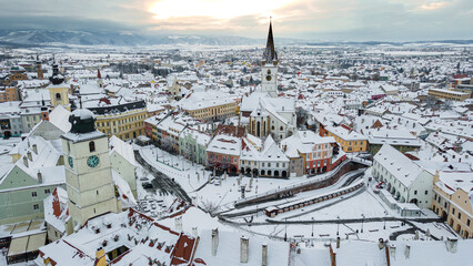 Drone photography of the city center of Sibiu, Romania. Photography was taken from a drone at a higher altitude in winter season with the town hall tower and the Evangelical Cathedral in the view.