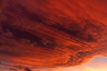 Huge orange cloud in the sky at sunset.