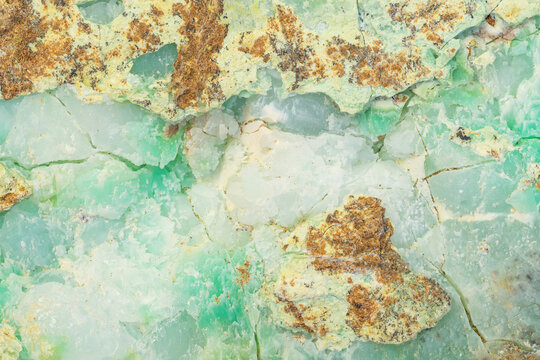Waxy surface of Chrysoprase mineral with visible traces of nickel in apple green parts of the texture