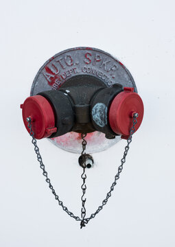 Auto sprinkler standpipe connector. Fire department connection covered outside of a building on a wall. Selective focus. Fire Department Connections for Sprinkler Systems and pump on the exterior wall