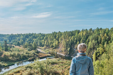 Senior woman hiker admiring nature landscape.