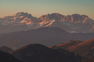 Naklejka premium The Lombard pre-Alps near Lake Iseo, seen at sunset from one of the most beautiful viewpoints in the Province of Brescia: Punta Almana, near the town of Sale Marasino, Italy - February 2023.