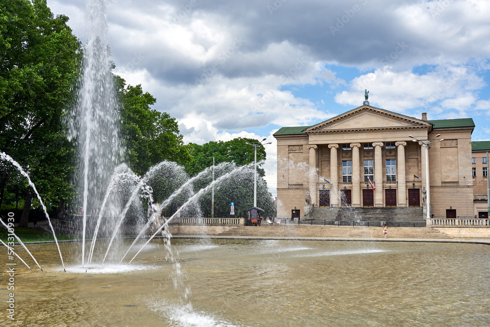 Wall mural fountain and classicist facade of an Opera building  in the city of Poznan