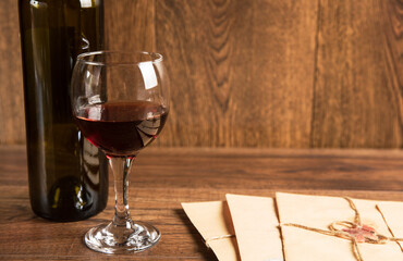 Vintage paper letter and glass of wine with bottle