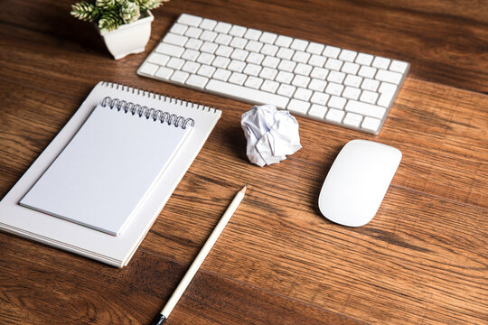 Notepad, crumpled paper and keyboard