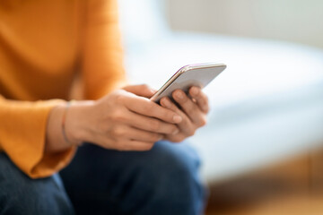 Closeup Shot Of Unrecognizable Woman Using Mobile Phone At Home