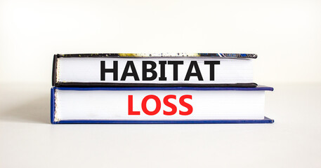 Habitat loss symbol. Concept words Habitat loss on books. Beautiful white table white background. Business habitat loss concept. Copy space.