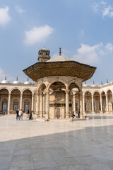 Obraz premium Inner courtyard of the Alabaster Mosque in Cairo on a sunny day, with some tourists.