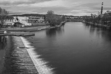 Fototapeta premium River Otava and weir with footbridge near Pisek town in south Czech in evening