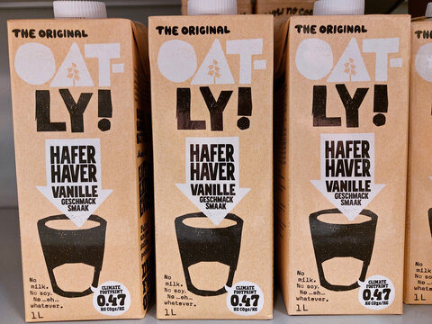 oatly alternative milk packages in a supermarket