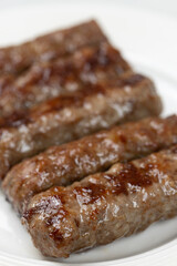 Fresh baked kebabs with minced meat served on the plate