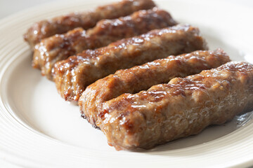 Fresh baked kebabs with minced meat served on the plate