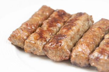 Fresh baked kebabs with minced meat served on the plate