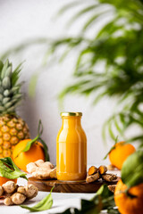 Fresh raw ingredients for detox ginger and curcumin smoothies and already blended mix in a bottles...