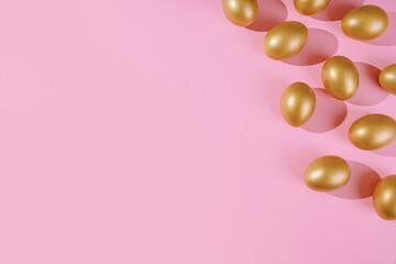 Easter template with golden egg border. Eggs painted gold on pink background. Easter concept with copy space for text. Flat lay style minimalistic design.