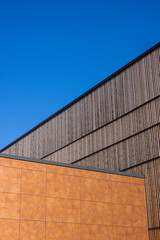 Corten steel, wood and blue sky. abstract architecture with geometrical patterns. Triangle shape.