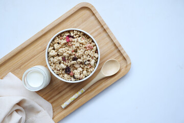 ranola Musli in a bowl and glass of milk on table 