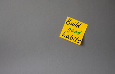 Build good habits symbol. Concept words Build good habits on orange steaky note. Beautiful grey background. Business and Build good habits concept. Copy space.