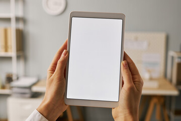 Close up female hands holding digital tablet with white screen mock up in office