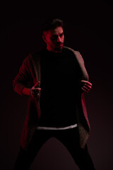 male model arranging his cardigan with style