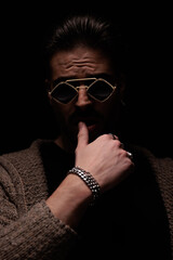 casual man pressing his lips with masculine frame