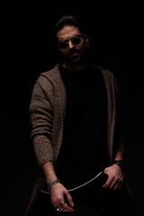 man posing with hands around body in a sexy stance