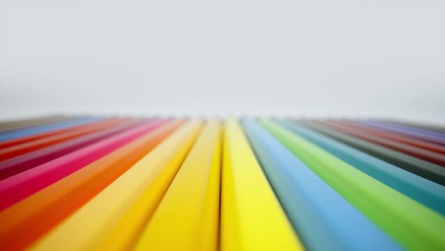 Extreme close-up colored pencils set on white background. Closeup multi-colored pencil set line up in a row, sharpened colorful pencils for drawing. Laowa 24mm probe lens, slider dolly macro shot
